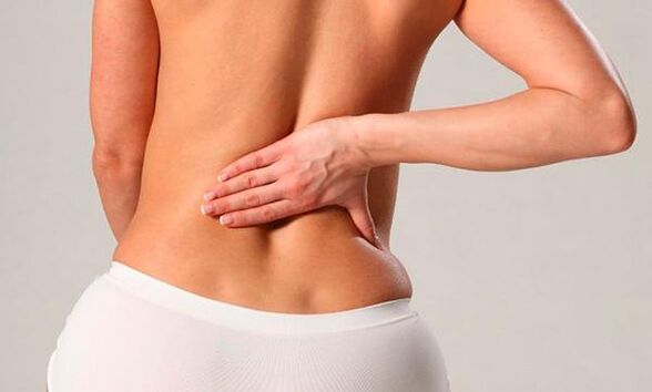 Back pain in the lumbar region of a woman